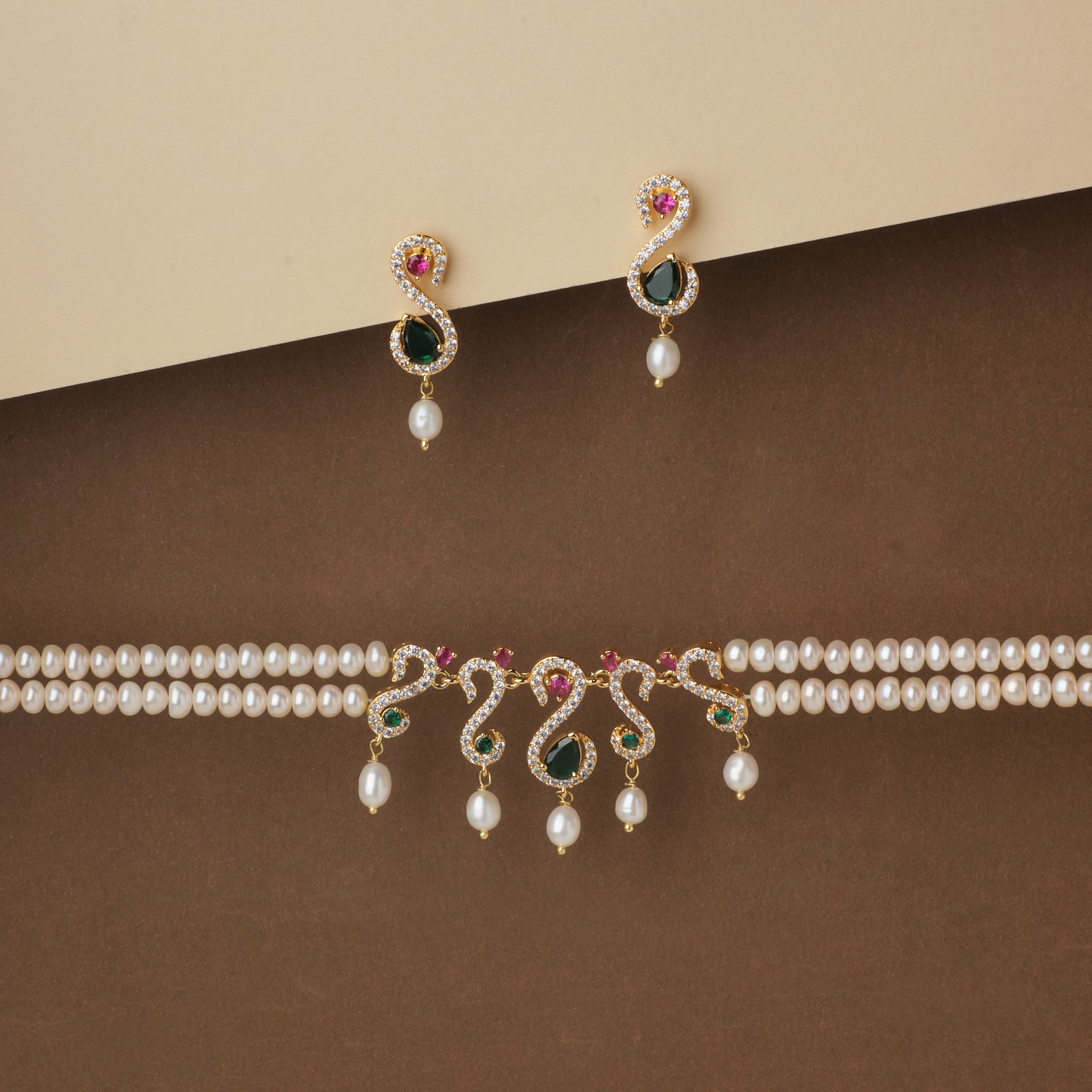 Elegant Ravishing Multi Stone Pearl Necklace Set and matching earrings with gemstone accents displayed on a two-tone backdrop by Chandrani Pearls.