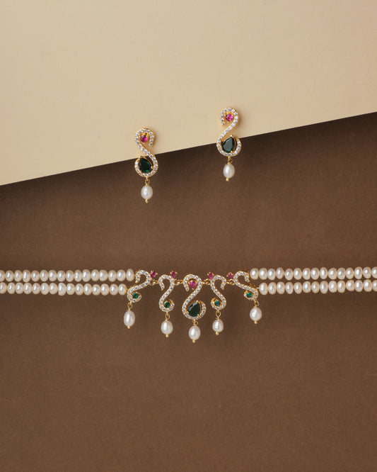 Elegant Ravishing Multi Stone Pearl Necklace Set and matching earrings with gemstone accents displayed on a two-tone backdrop by Chandrani Pearls.