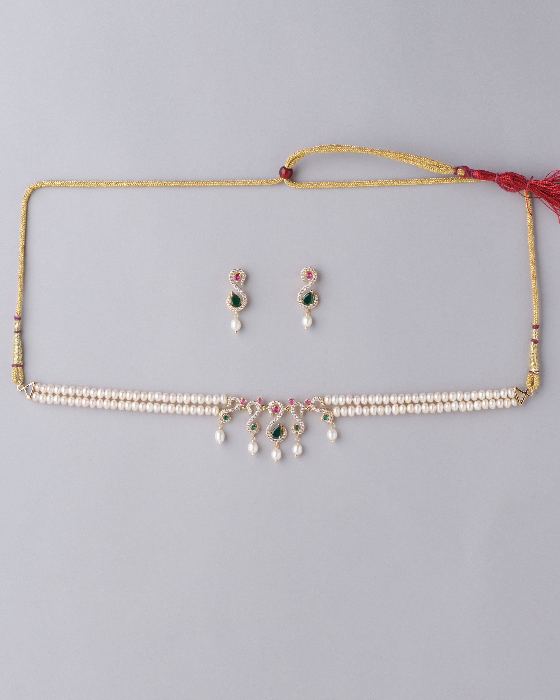 Ravishing Multi Stone Pearl Necklace Set by Chandrani Pearls with matching earrings on a neutral background.