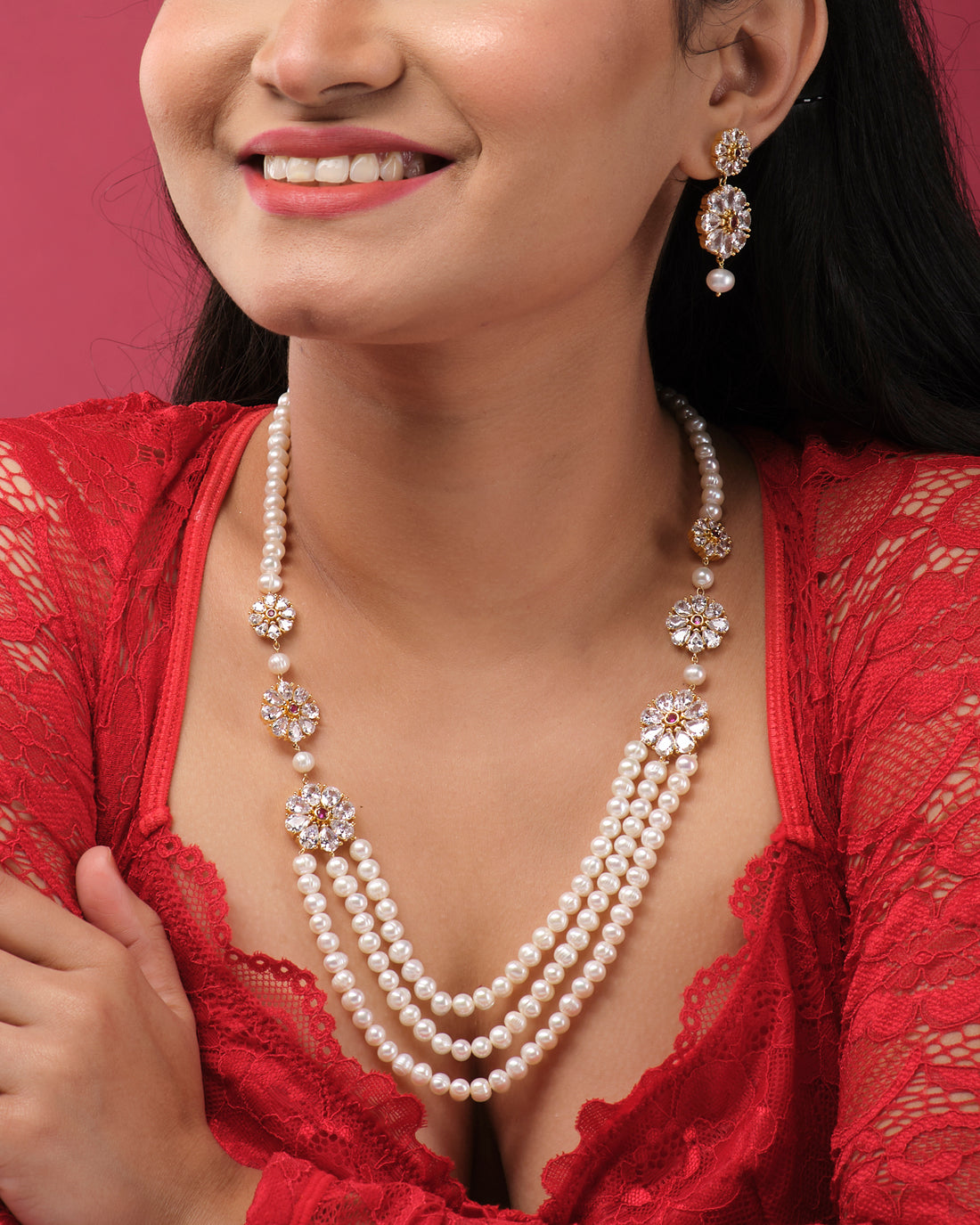 A white display stand features the Flory Double Side Necklace Set by Chandrani Pearls India—a sophisticated three-layer pearl necklace with gold and stone accents, paired with matching pearl drop earrings.