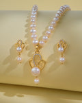 The Elegant Pearl Necklace Sets by Chandrani Pearls India, featuring a necklace and matching earrings, are displayed on a light beige background to highlight the pearls' natural beauty.