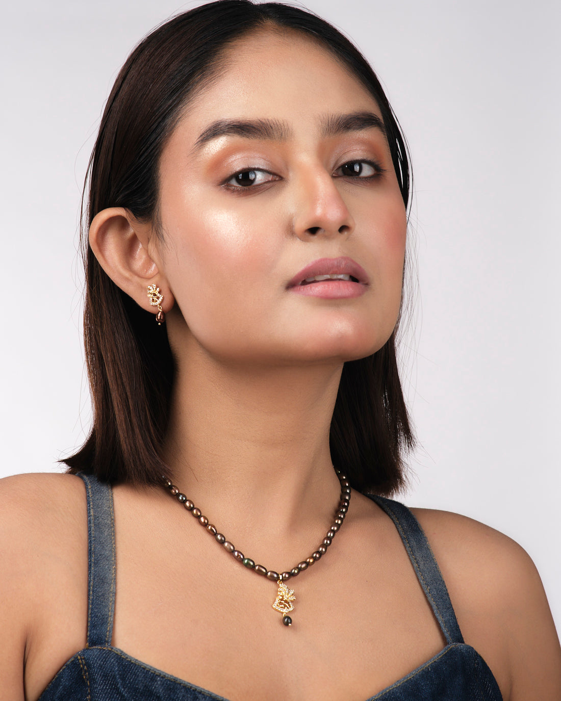 The Chandrani Pearls India Beautiful Pearl Necklace Sets feature intricate designs, pearls, and crystal accents that celebrate natural beauty against a light yellow background.