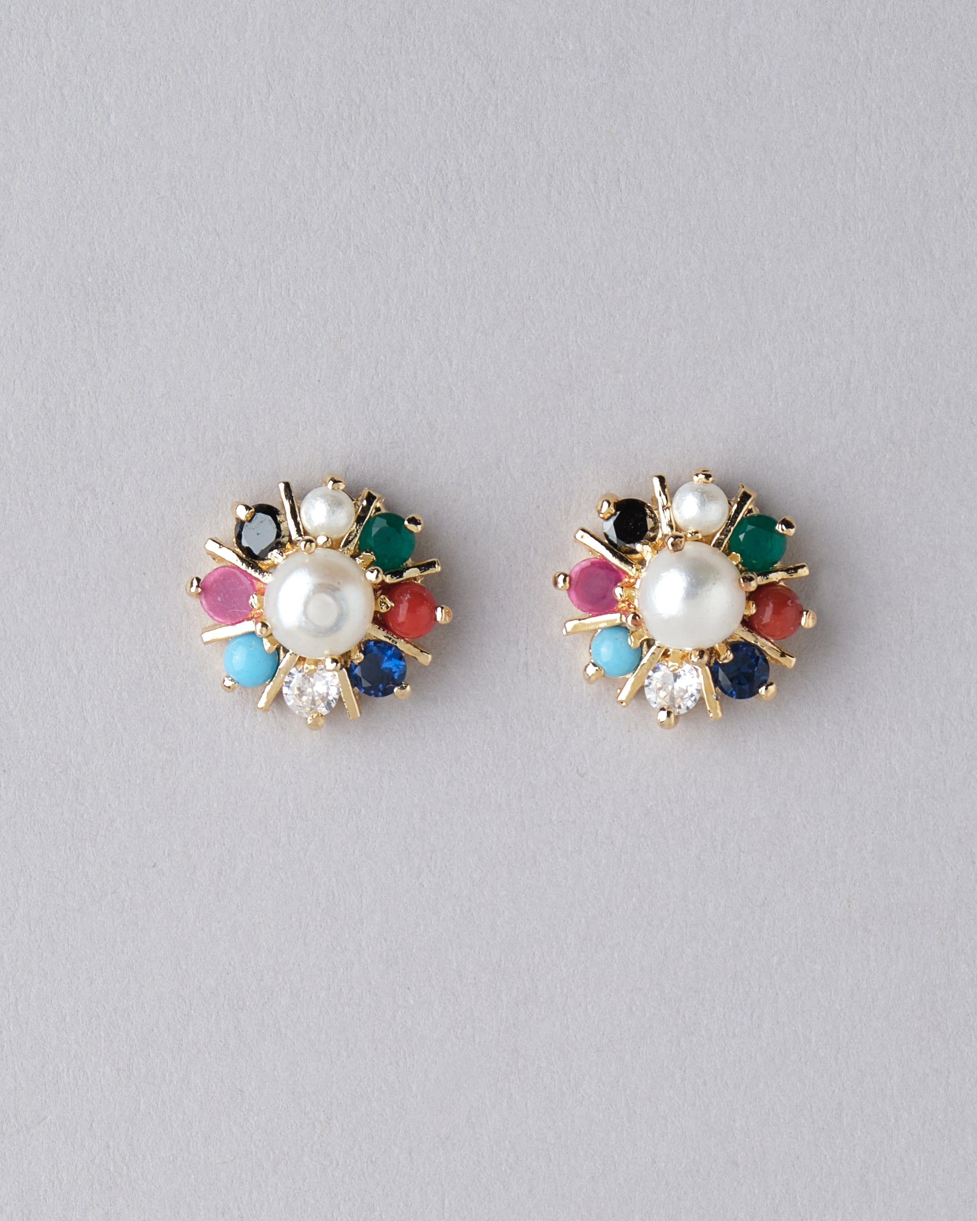 A pair of Navratan CZ Stud Earrings by Chandrani Pearls India with different colored stones.
