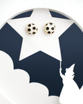 Football Style Stud Earrings from Chandrani Pearls India are showcased on a star cutout featuring a silhouette of a figure in a hat pointing a wand.