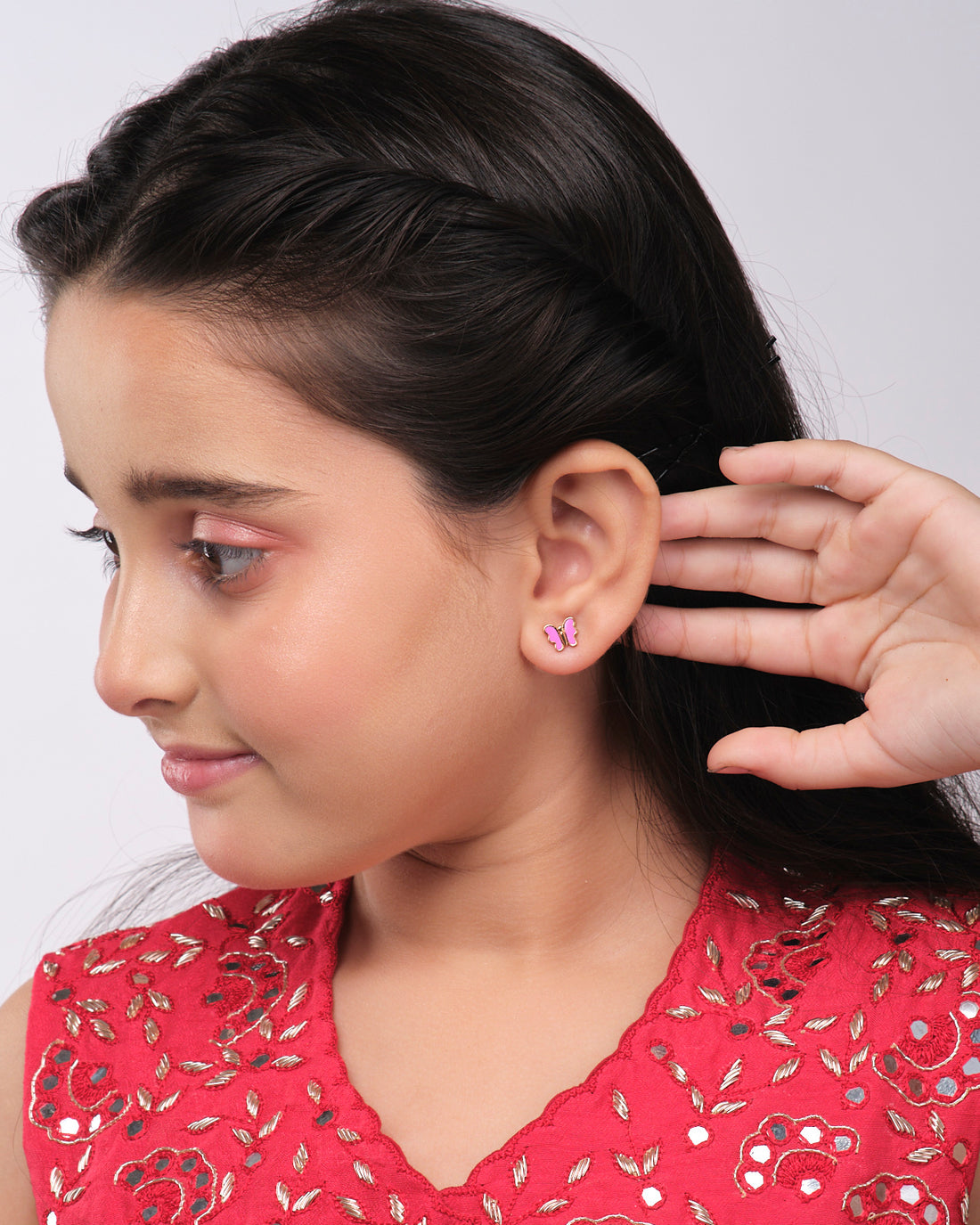 The Pretty Pink Butterfly earrings by Chandrani Pearls India are displayed on a star cutout, with a girl's silhouette holding an umbrella in the foreground.