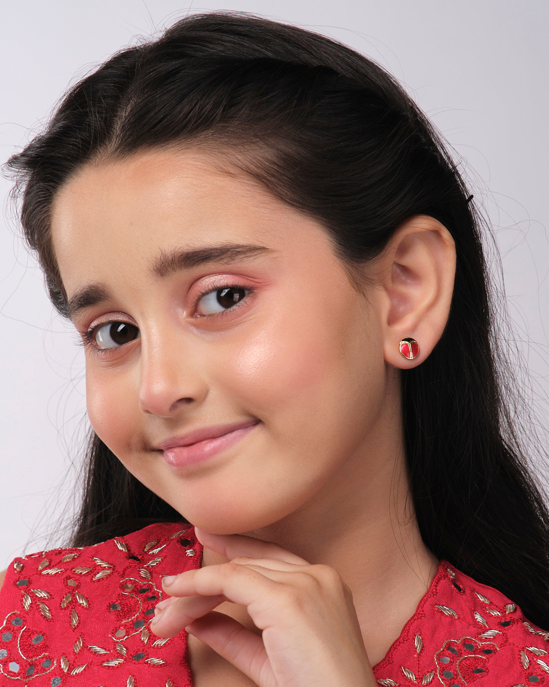 Chandrani Pearls India's Cute Stud Earrings feature a red and black round design on a white star-shaped cutout, complete with a casting figure silhouette at the bottom.