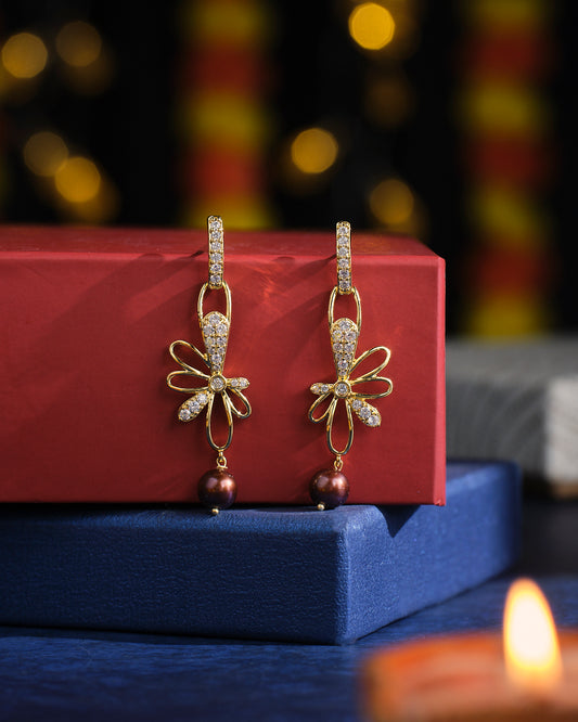 Prema raga- Love Colour Pearl Earrings by Chandrani Pearls, adorned with a floral design and pearl drops, displayed on red and blue boxes.