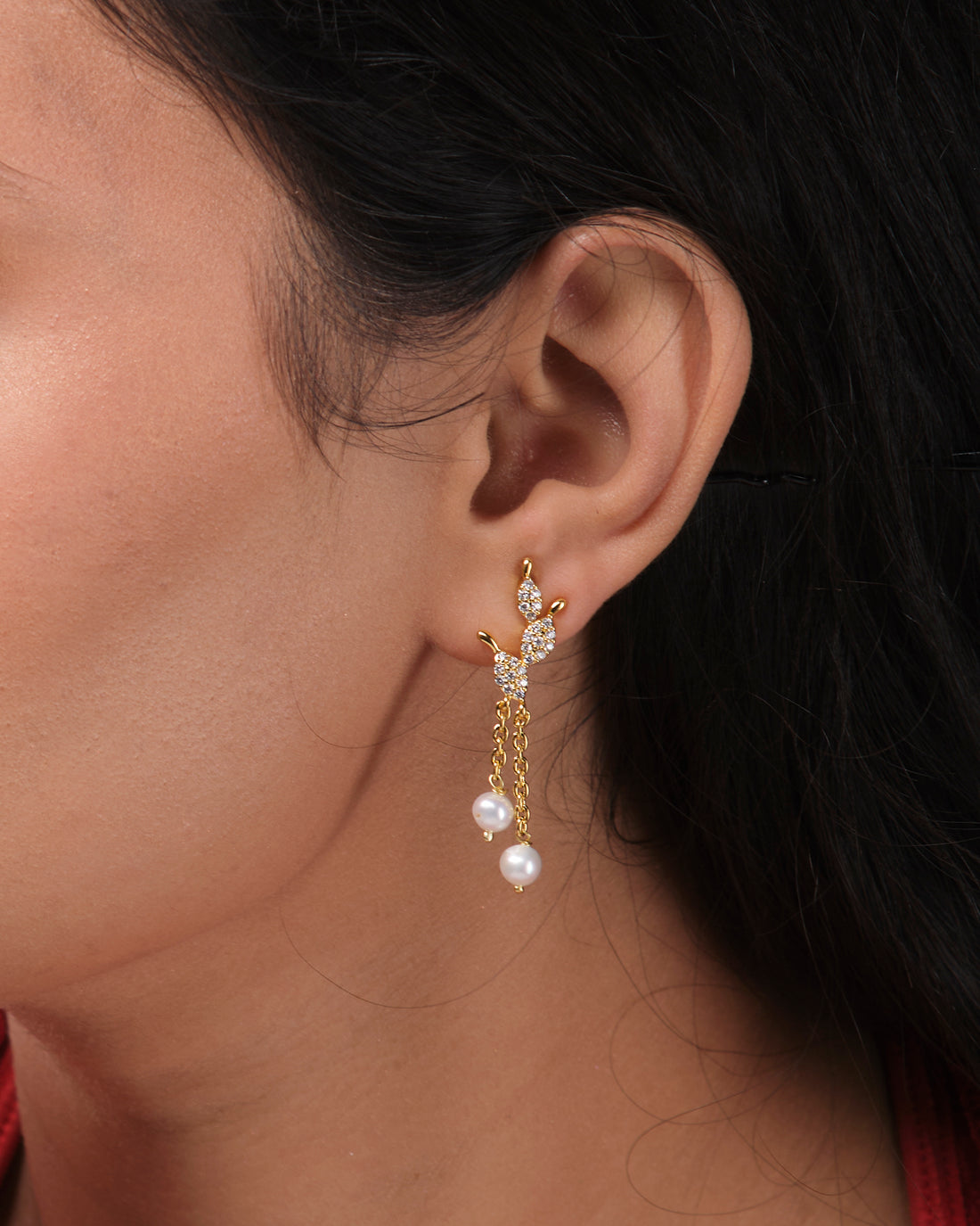 Cute Hang Earrings by Chandrani Pearls India feature butterfly tops, sparkling crystals, and dangling pearls for a sophisticated touch. Presented stylishly on a white block, they’re perfect to elevate any outfit.