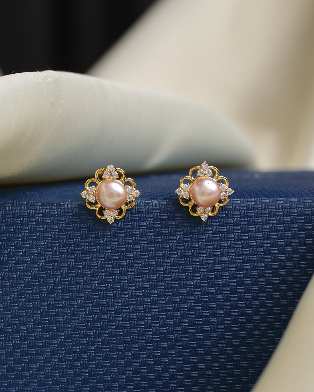 Timeless elegance meets modern sparkle with these Chandrani Pearls pearl and CZ stud earrings, featuring round pearls surrounded by clear gemstones—an ideal choice for everyday wear or special occasions.