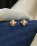 Timeless elegance meets modern sparkle with these Chandrani Pearls pearl and CZ stud earrings, featuring round pearls surrounded by clear gemstones—an ideal choice for everyday wear or special occasions.