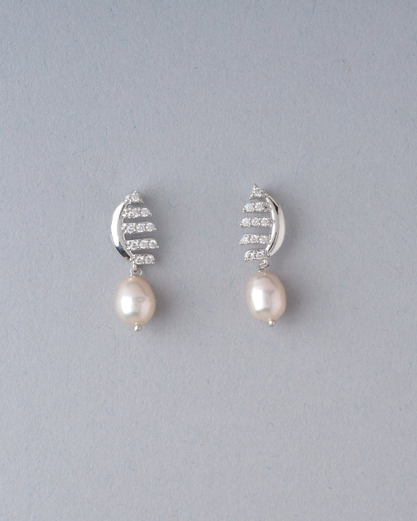 Classic pearl studs are upgraded with a CZ-studded border