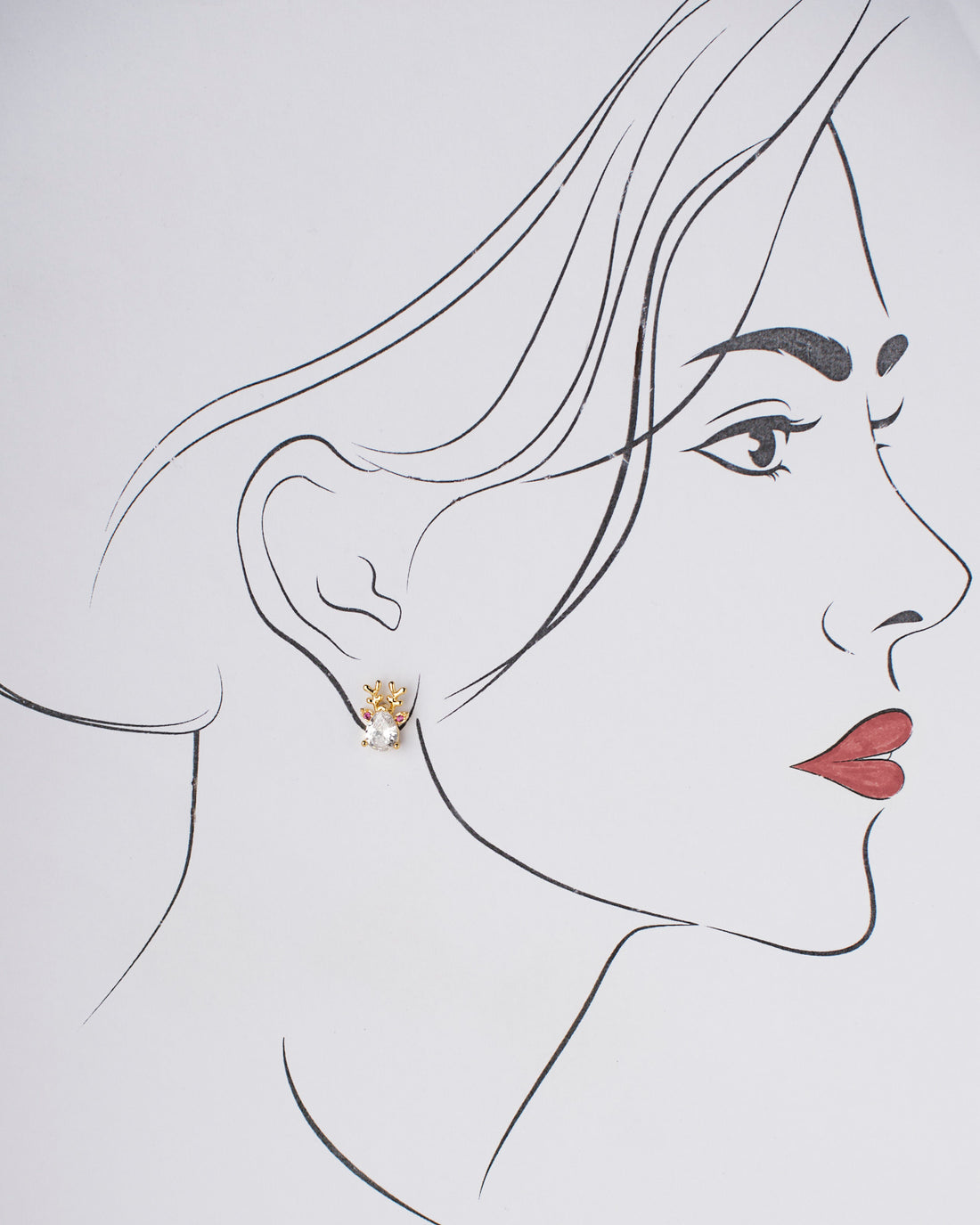 Chandrani Pearls' Sparkling Drip Earrings feature reindeer design with clear teardrop gems and pink accents, set against a white surface.