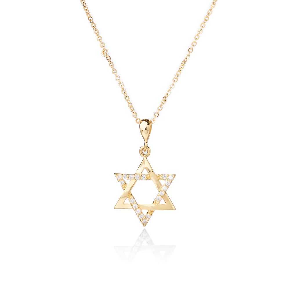 A person wearing a white blazer showcases The Star of David Pendant from Chandrani Pearls, a symbol of unbreakable ties.